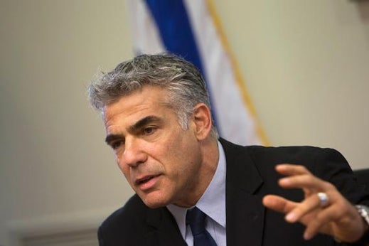 Israel's Finance Minister Yair Lapid gestures as he speaks during a Yesh Atid party meeting at the Knesset, the Israeli parliament, in Jerusalem, May 20, 2013.